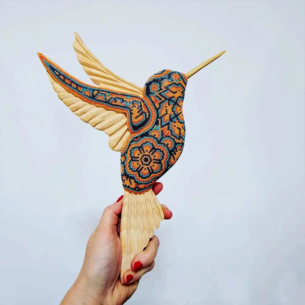 wooden hummingbird decorated with beads in the style of huichol art, mexican crafts