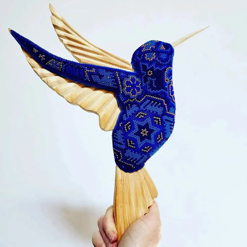 wooden hummingbird decorated with beads in the style of huichol art, mexican crafts