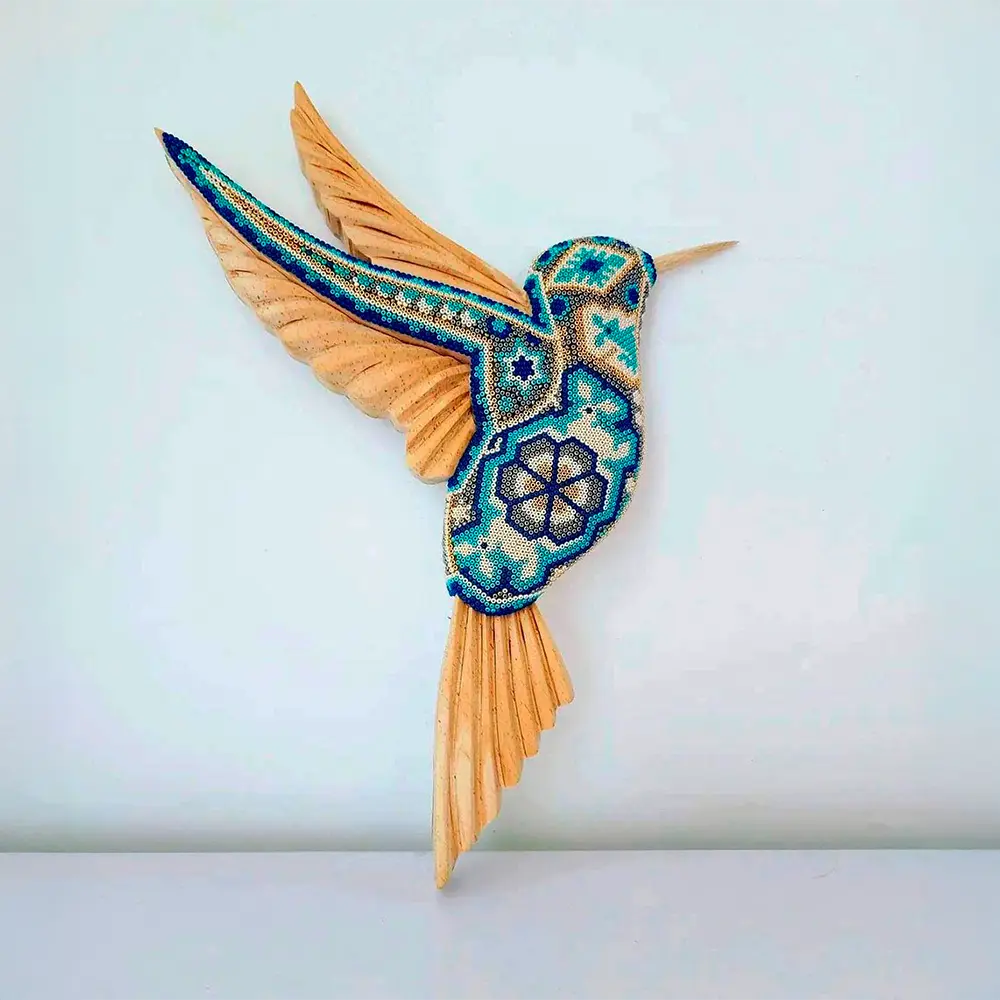 wooden hummingbird decorated with beads in the style of huichol art, mexican crafts