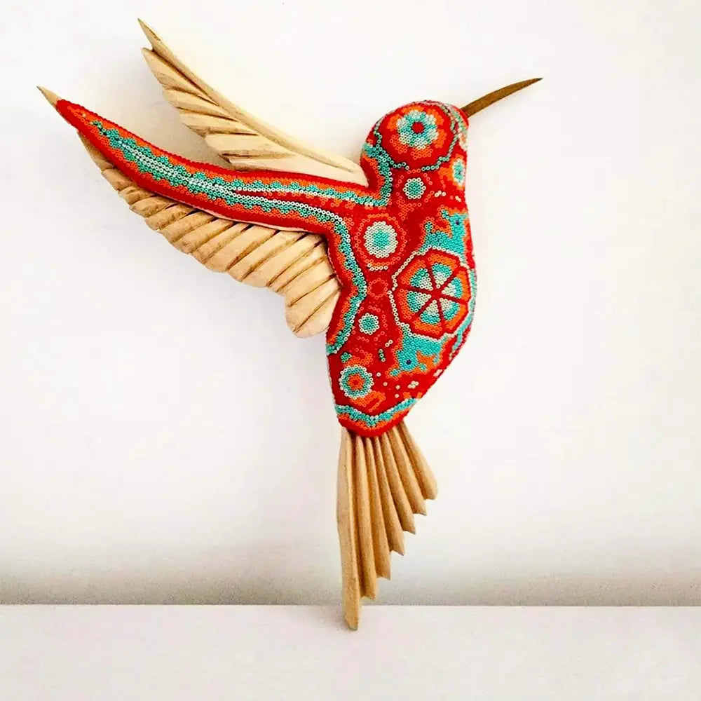 wooden hummingbird decorated with beads in the style of huichol art, mexican crafts
