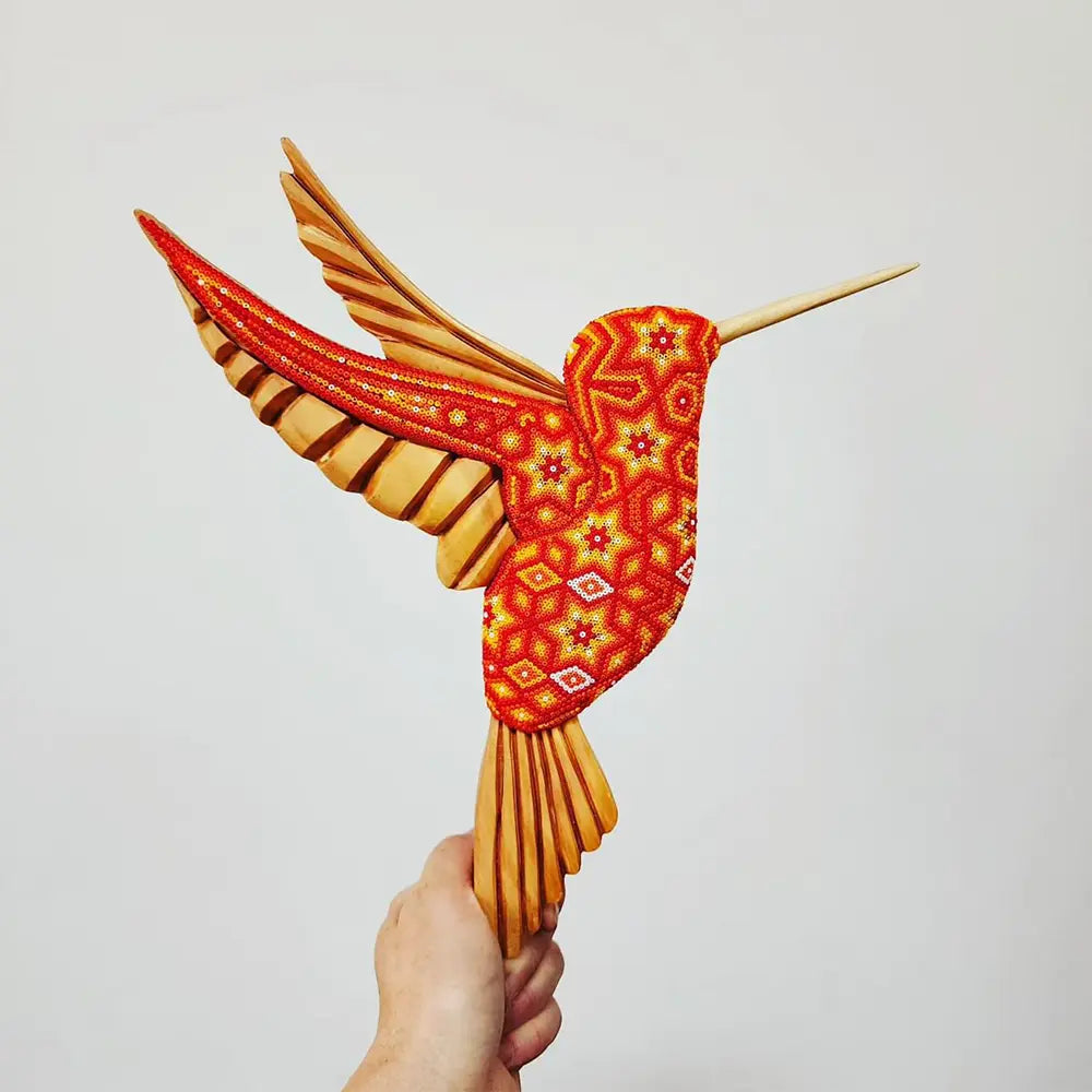 wooden hummingbird decorated with beads in the style of huichol art, mexican crafts