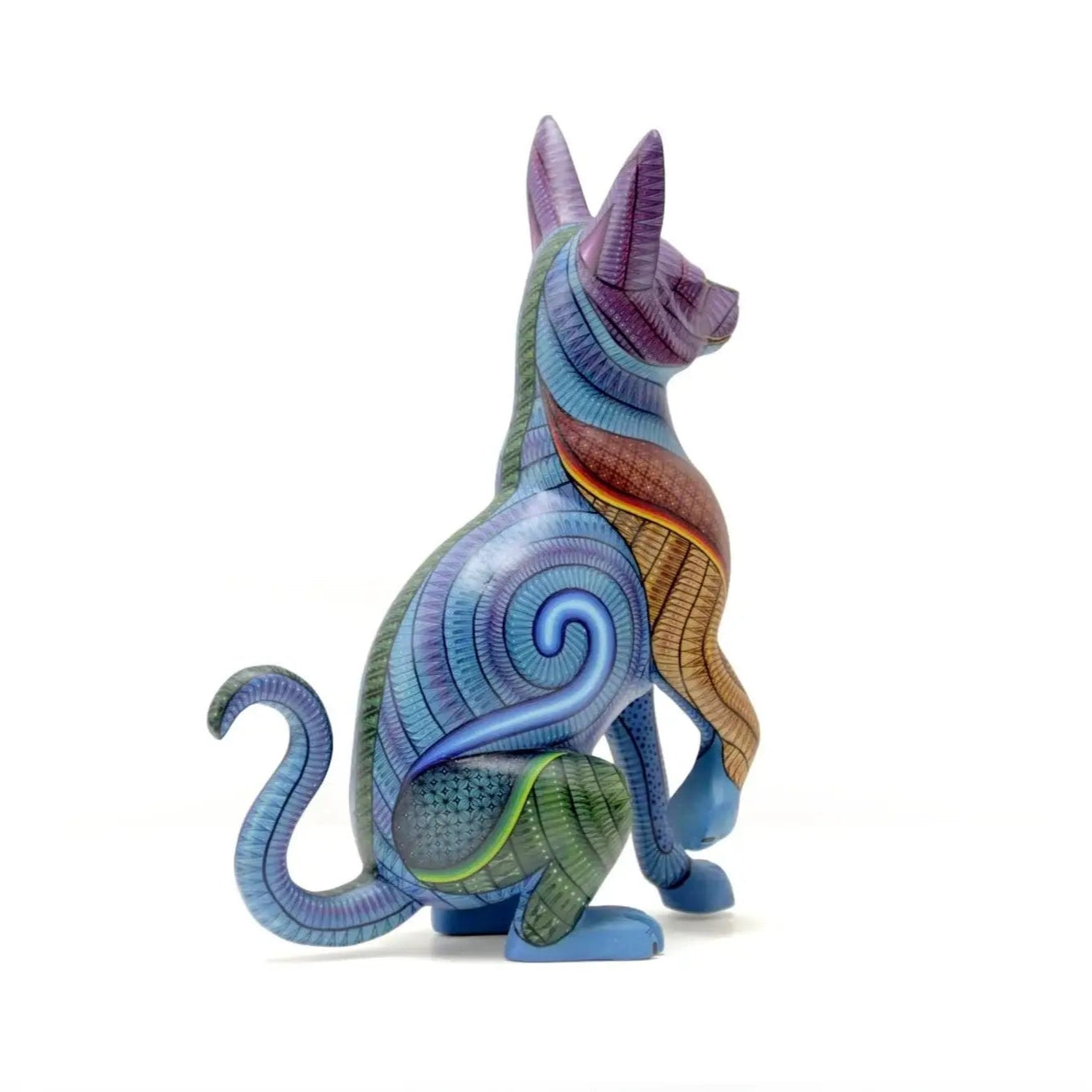 Colorful hand-painted hunting dog alebrije with intricate patterns, symbolizing protection and instinct in Mexican folk art, displayed under natural light with tropical plant shadows