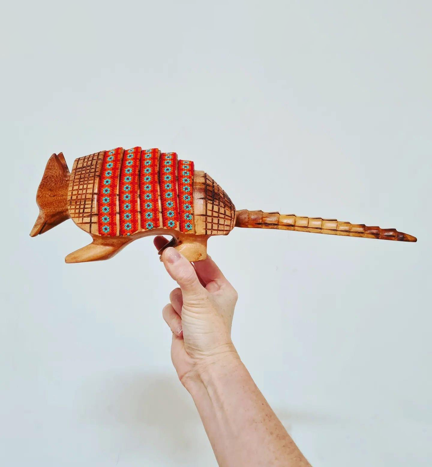 wooden armadillo figurine decorated with beads in the style of huichol art