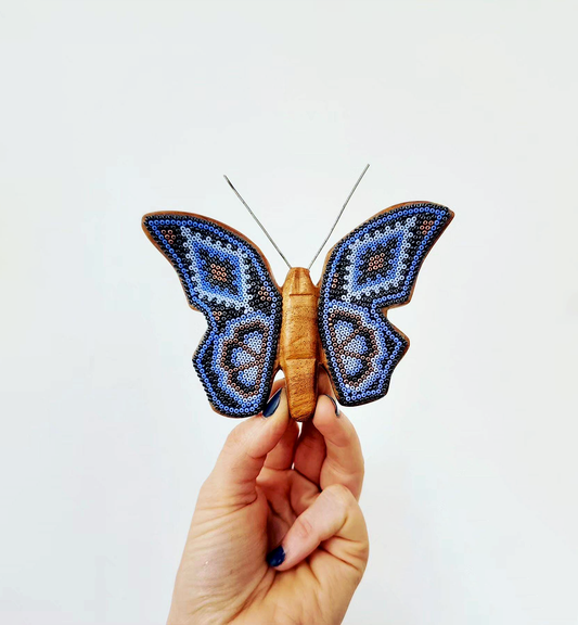 Wooden butterfly figurine with beads