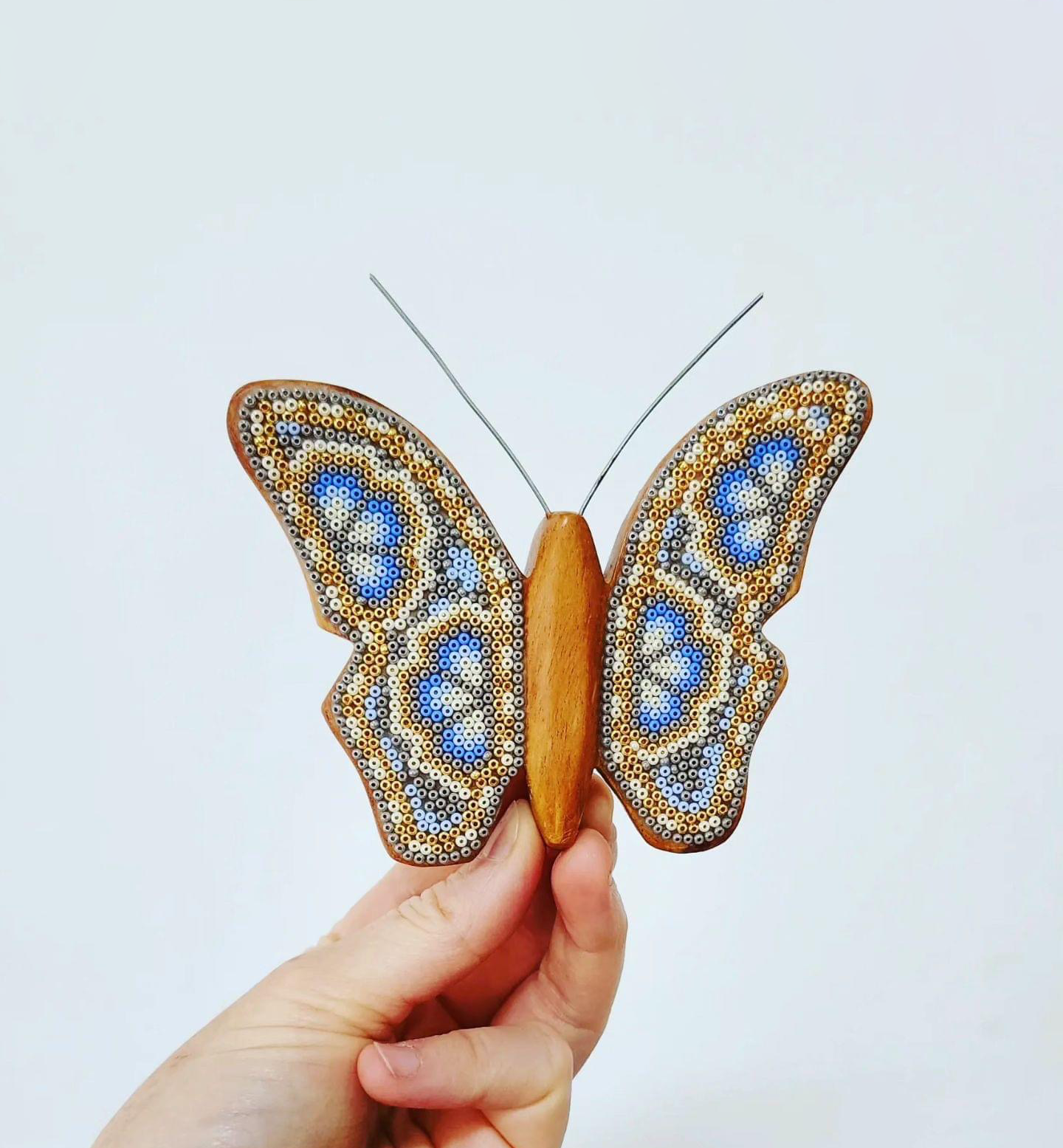 Wooden butterfly figurine with beads