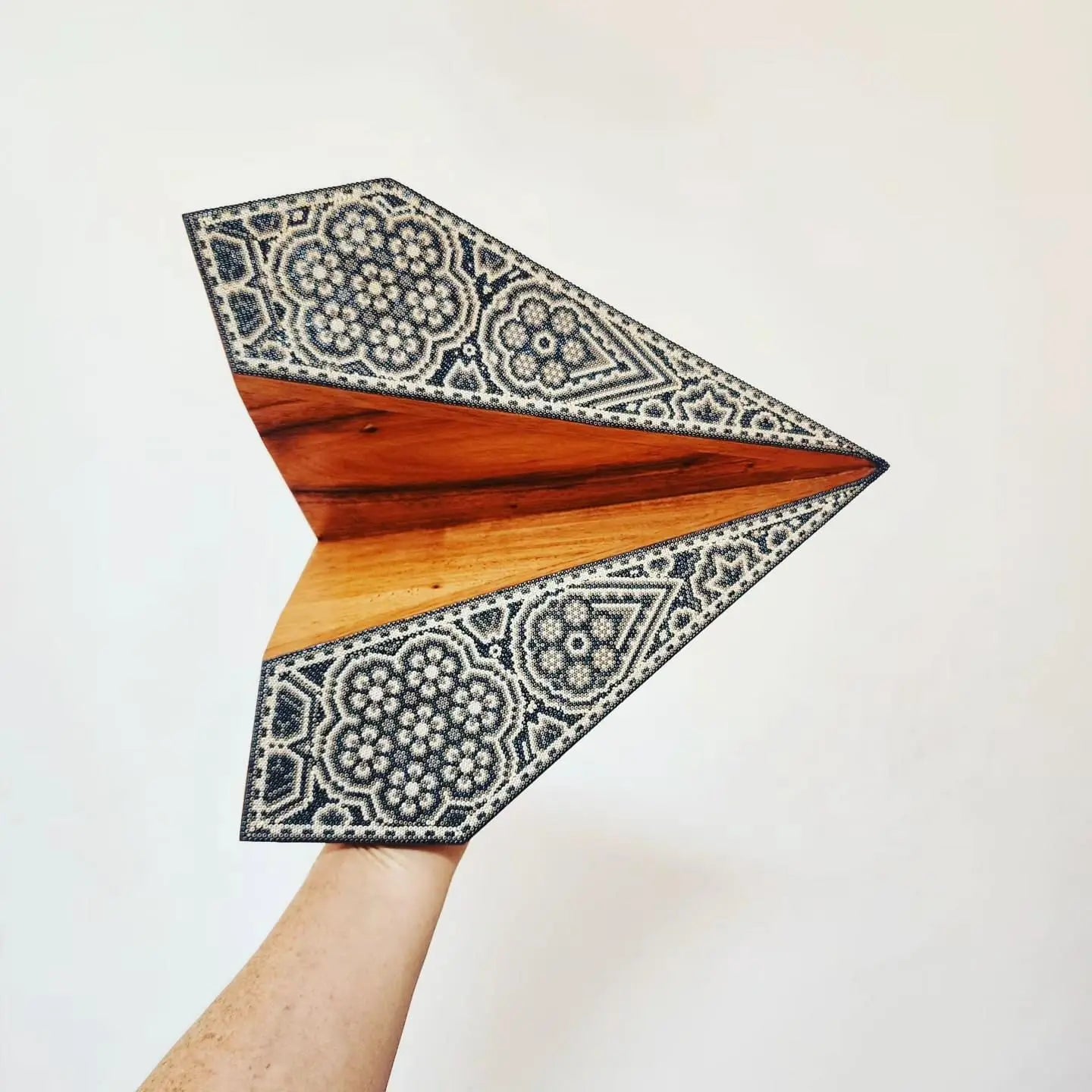 handmade wooden paper-plane figurine decorated with authentic huichol beadwork