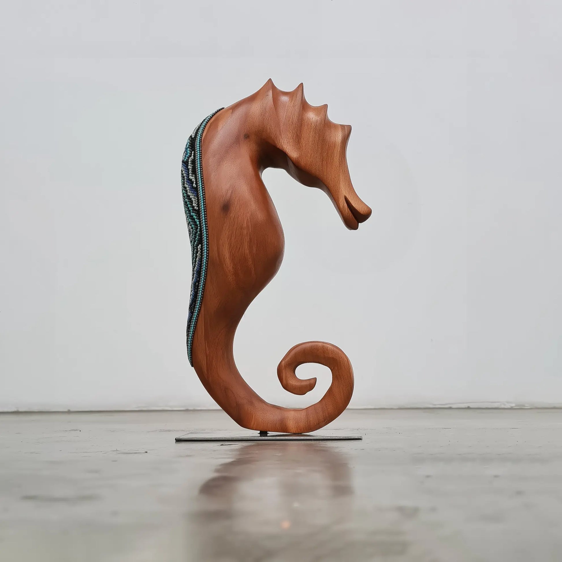 wooden seahorse decorated with beads in the huichol style