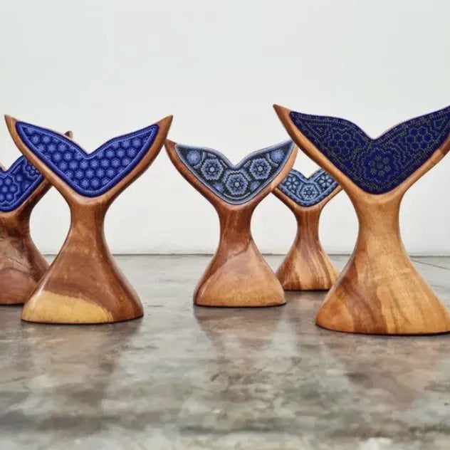wooden whale tail figurine decorated with beads in the style of huichol art, mexican crafts