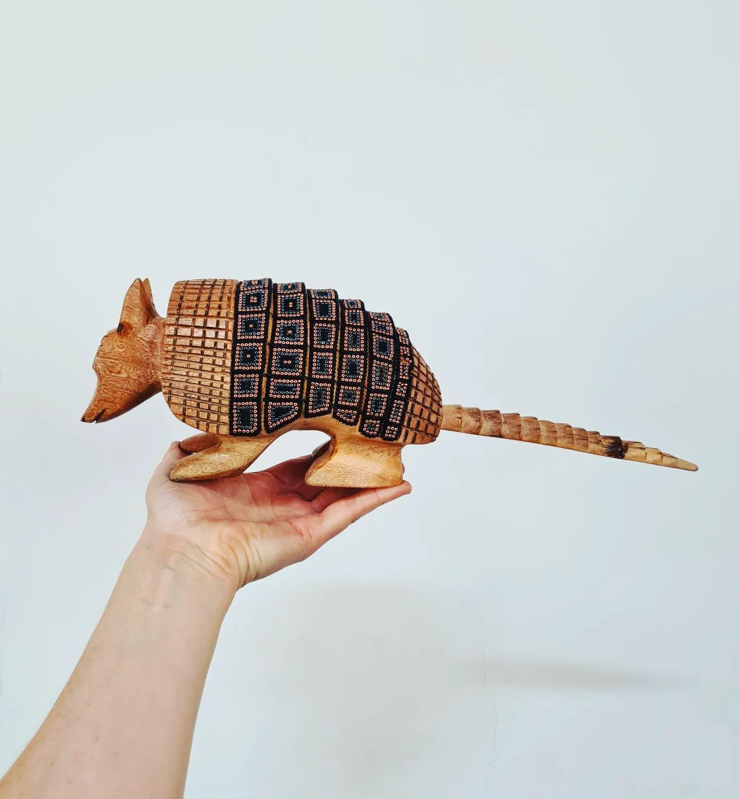 wooden armadillo figurine decorated with beads in the style of huichol art